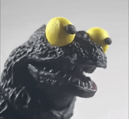 a close up of a statue of a monster with yellow eyes .