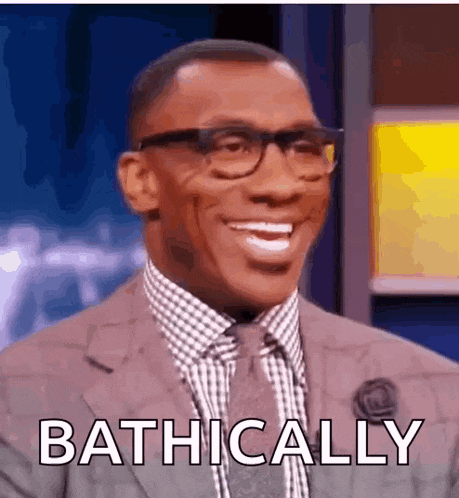 a man in a suit and tie is smiling with the words bathically written below him .