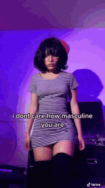 a woman in a striped dress says i dont care how masculine you are on a tiktok video