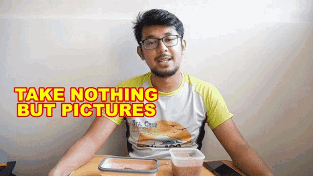 a man sitting at a table with the words take nothing but pictures