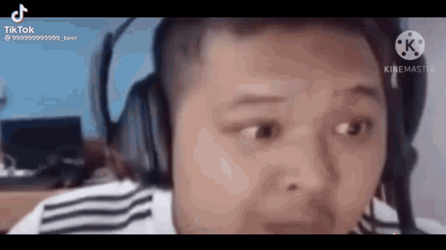 a man wearing headphones is making a funny face while looking at the camera .