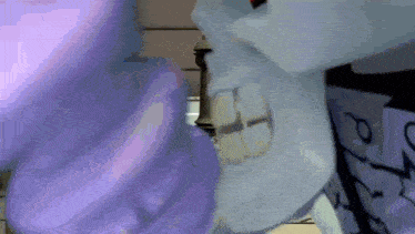 a close up of a person 's face with a purple object in the background .