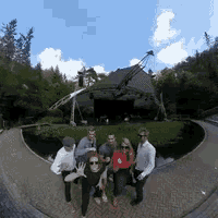 a group of people are posing for a picture in front of a building