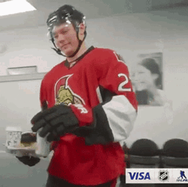 a hockey player wearing a jersey with the number 2 on it