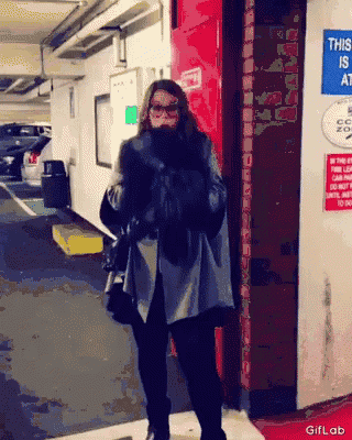 a woman is standing in front of a sign that says this area