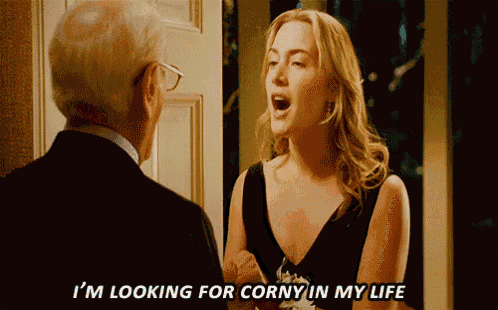 a woman in a black dress says i 'm looking for corny in my life to a man in a suit