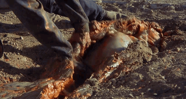a person is laying in the dirt with their feet covered in mud
