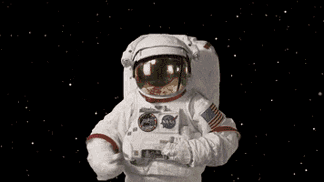 an astronaut is holding a mistletoe in space