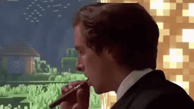 a man in a suit is smoking a cigar while looking out a window at a minecraft world .