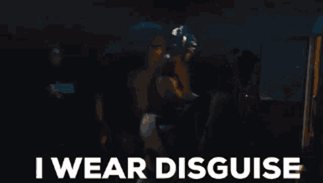 a group of people standing in a dark room with the words " i wear disguise " written on the bottom
