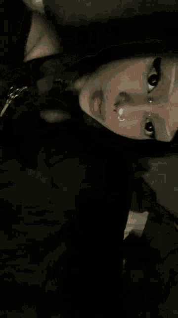 a close up of a person 's face with a reflection of a person in the mirror .
