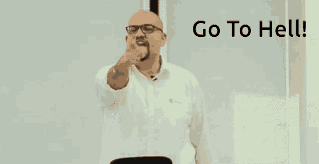a man with glasses and a beard is making a go to hell gesture