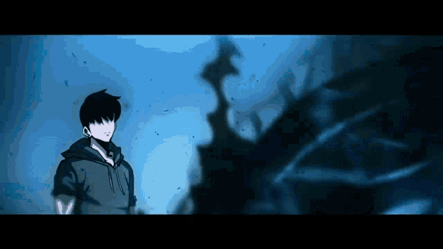 a man in a hoodie is standing in a dark room with a shadow behind him