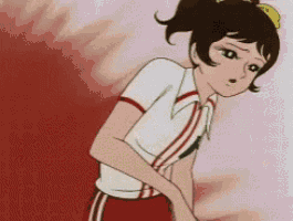 a girl in a white shirt and red shorts is standing in front of a red background .