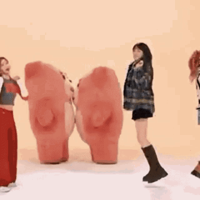 a group of girls are dancing in a room .