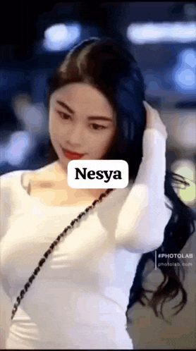 a woman in a white dress with the name nesya written on her face