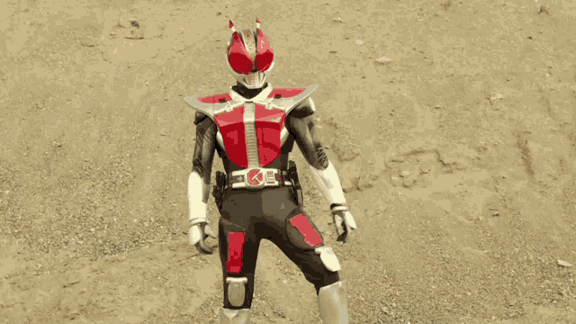 a man in a superhero costume with a belt that has the letter t on it