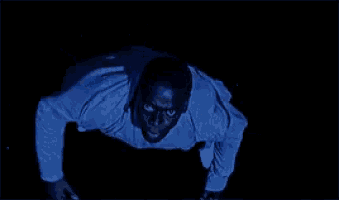 a man in a blue shirt is flying through the air .