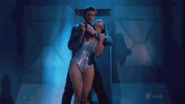 a couple of women standing next to each other in a room .