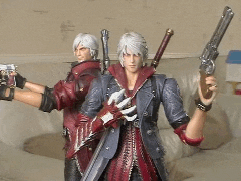 two devil may cry action figures are standing next to each other holding guns .