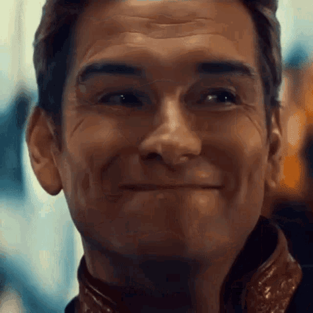 a close up of a man 's face smiling .