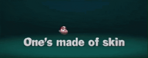 a man in a suit is standing in front of the words who 's the dummy
