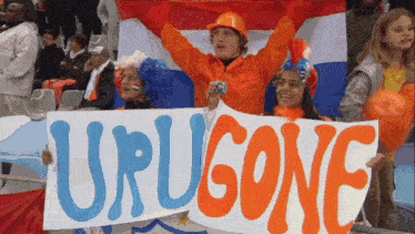 a group of people hold up a sign that says urugone