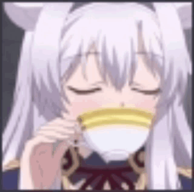 a close up of a girl drinking from a cup of tea .