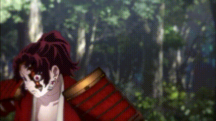 a man in a red jacket is standing in the woods .