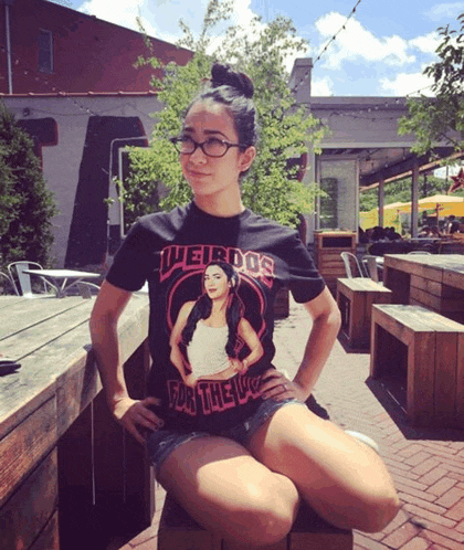 a woman wearing a weirdos for the love t-shirt