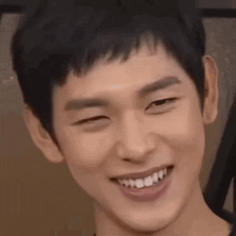 a close up of a man 's face with his eyes closed and smiling .
