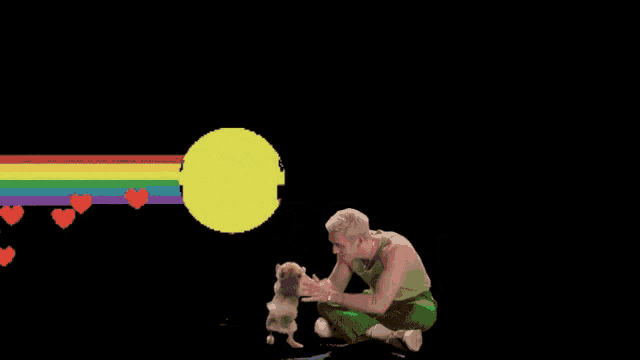 a man sitting next to a small dog with hearts and a smiley face behind him