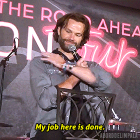 a man speaking into a microphone with the words my job here is done