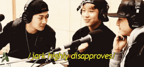 a group of young men are sitting in front of a microphone and one of them is saying " jerk highly disappoints "