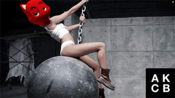 a woman wearing a red cat mask is sitting on a large ball