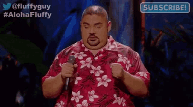 a fat man in a hawaiian shirt is holding a microphone and giving a speech .