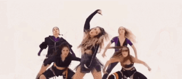 a group of women are dancing together on a white background in a video .