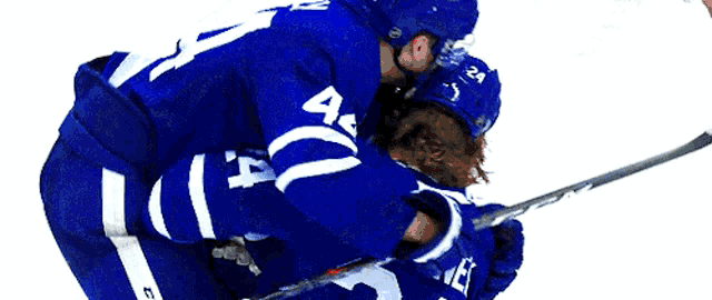 a hockey player in a blue jersey with the number 14 on it