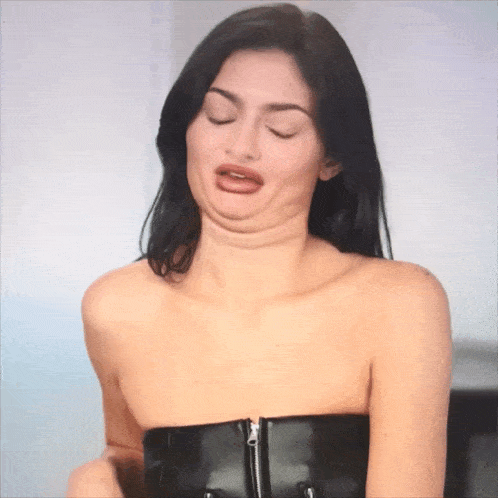 a woman without a shirt is making a face with her mouth open