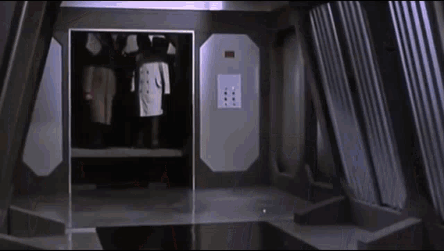 a group of people standing in an elevator with a sign on the wall that says " emergency exit "