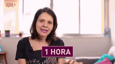 a woman with a purple sign that says 1 hora on it