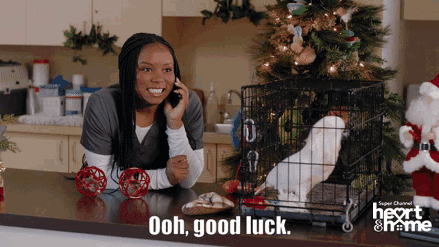 a woman talking on a cell phone next to a dog in a cage with the words ooh good luck below her