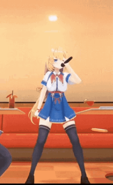 a girl in a blue dress is singing into a microphone in a room