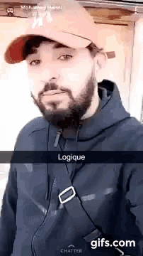 a man with a beard is wearing a hat and a black jacket ..