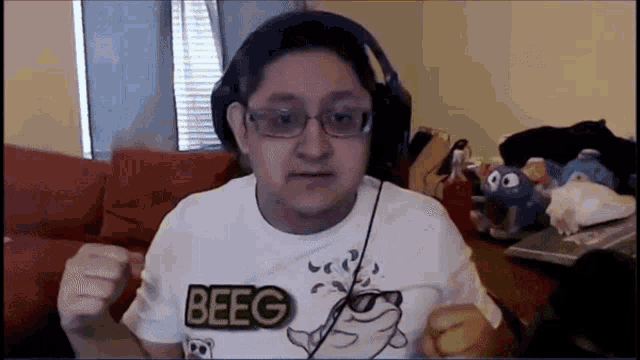 a man wearing headphones and a white shirt that says beeg