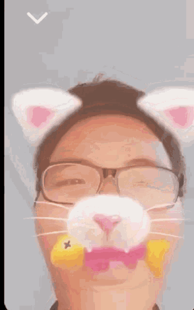 a man wearing glasses and a cat mask with pink ears