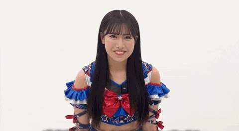 a woman in a sailor moon costume is waving her hands .