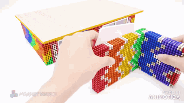 a model of a building made out of magnets with the words magnetworld made in animatica on the bottom