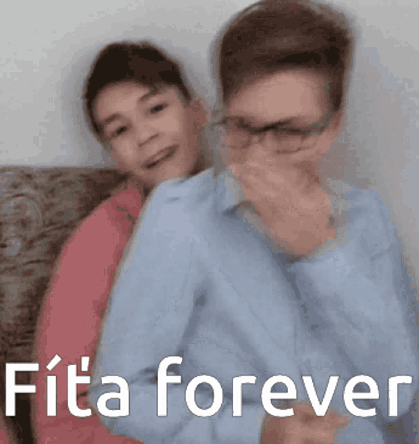 two boys are sitting on a couch and one of them is covering his mouth with his hand and the caption says fita forever