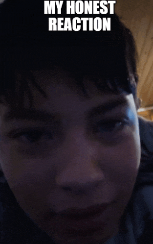 a close up of a person 's face with the caption " my honest reaction " above it